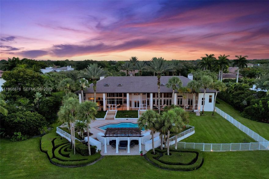 Discover timeless elegance in this Spectacular Custom Estate situated on a private cul-de-sac lot in the prestigious Windmill Ranch Estates. This residence offers over 8,600 sq ft of luxurious living area on a beautiful 1.32 acre lot. 5 Bedrooms, 6 Full & 2 Half baths PLUS lifestyle amenities including a 2 story primary retreat with fireplace, office, library, loft/billiard room, gym, and wine cellar. Gourmet kitchen with top tier appliances, custom cabinetry, and built-in aquarium. Enjoy outdoor living and entertaining with the resort style pool, expansive screened terrace, pergola, teak summer kitchen with bar overlooking the BREATHTAKING PANORAMIC LAKE VIEWS! Additional features include a serene courtyard with rock waterfall, 4 car side entry garage, impact windows, and 2018 roof.