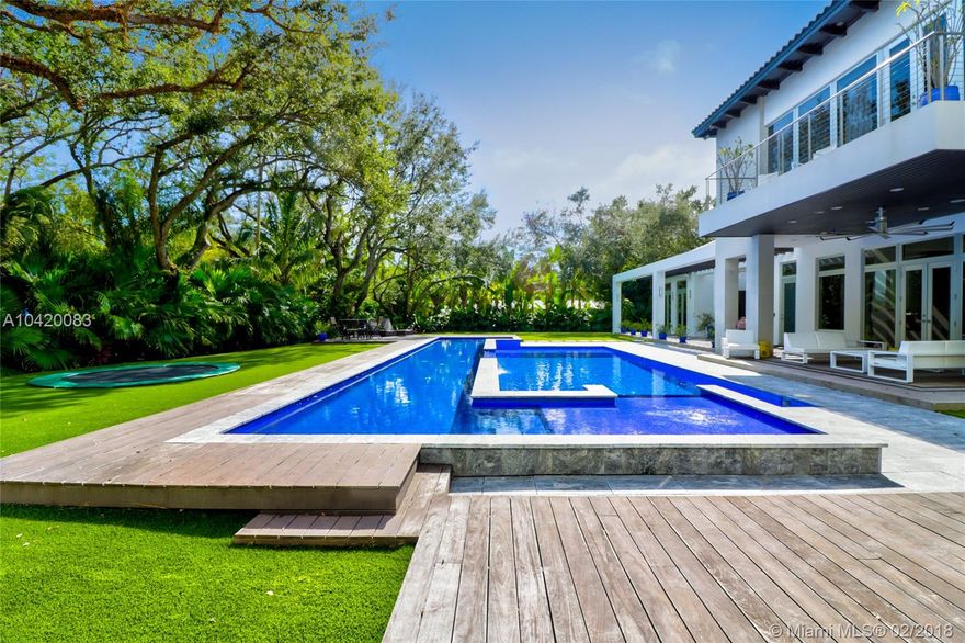 Flawless contemporary Ponce-Davis home. Custom built 2008, renovated to perfection 2014 with Brazilian Ipe, limestone, and marble floors, state-of-the-art air/water filtration, entry pond & waterfalls, multi-zone pool with salt-water purification and Badu swim gym. Huge 1-acre lot provides ample natural light, seamless indoor/outdoor living, complete summer kitchen/bbq, full wet bar, custom sound system, and professional Arclinea kitchen w/Gaggenau gas cooktop, double ovens, double refrigerators, and more. All 5 main bedrooms include Arredo Italian closets and en-suite baths. 2 powder rooms plus separate guest suite and detached staff quarters. CGI Impact Windows and whole-house gas generator for year-round safety and comfort.