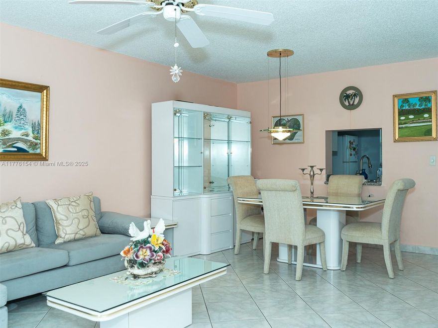 Charming Condo with Pool View and Resort-Style Amenities This bright and inviting 2-bedroom, 2-bathroom condo offers a functional open-concept layout with neutral tones, ideal for comfortable living and entertaining. The white kitchen features cabinetry, classic appliances, and a practical design perfect for everyday use. Both bedrooms are tranquil retreats with soft lavender accent walls and personal touches. The main bathroom is clean, modern, and well-appointed. Enjoy your mornings on the private screened-in patio overlooking lush gardens and the sparkling pool. Community amenities include a resort-style pool, BBQ area, and shaded lounge spaces. Conveniently located just minutes from Mizner Park, top dining, beaches, shopping, and public transportation.HOA includes fiber-optic internet.
