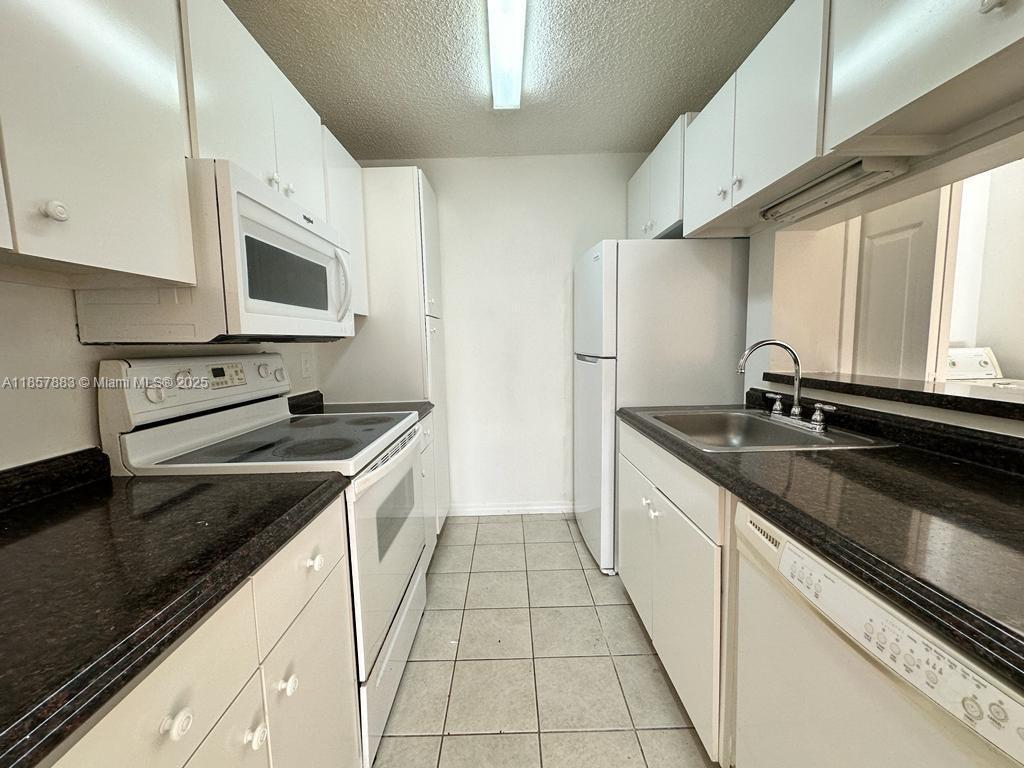 Luminous 1/1 unit with screened balcony and storage. Laminated floors and upgraded kitchen. Washer and dryer in the unit. Walk-in closet. PERFECTLY & CENTRALLY LOCATED, in well-maintained Palm Aire community, between the Turnpike and I-95. Easy access to beaches, close to Shopping Center. 1 Parking space assigned and Guest spaces available. Community has 2 swimming pools, 2 tennis courts and fitness center. Management on site.