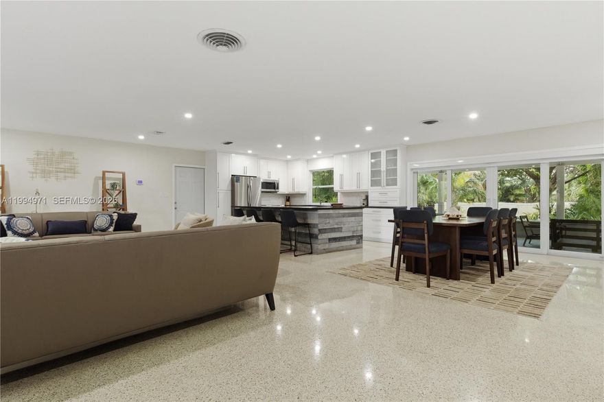 Tucked away in one of South Miami’s most sought-after neighborhoods, this elegant furnished residence offers a rare blend of space, privacy, and natural beauty—just minutes from The Falls Shopping Center, fine dining, and top-rated schools. The home features an open-concept layout designed for both comfort and entertaining, with sunlit living spaces, refined finishes, and a seamless flow that create an inviting atmosphere throughout. A standout feature is the fully finished, air-conditioned garage, thoughtfully designed as a flexible living area—ideal for use as an additional bedroom, playroom, TV/game room, or home gym, and complete with a sleeper sofa for convenient guest accommodations or extended stays. The outdoor experience truly sets this property apart, with an expansive garden that feels like a private retreat, showcasing a tranquil lake, multiple fish ponds, and lush landscaping with mature trees. Winding paths invite you to explore, while the generous yard provides the perfect setting for gatherings or peaceful moments surrounded by nature. Offered fully furnished and move-in ready, this home is ideal for professionals, families, or athletes seeking a distinctive Miami lifestyle with space to live, entertain, and unwind.