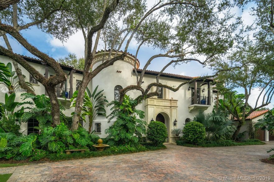 This two-story 7 BR/6+2 BA, gated Italian villa by Giorgio Balli in Ponce Davis, has 9,071 SF with a 2 car garage. The first floor features a double-height foyer, wood and marble floors, custom cabinetry, and moldings throughout. Downstairs also includes a gourmet kitchen, family room, formal living room, bar with an indoor seating area plus outdoor sunroom, movie theatre, and kids playroom. Upstairs are the grand luxe master bedroom, master bathroom, 2 master closets, office, and 3 additional bedrooms with bathrooms and balconies. The backyard has a summer kitchen, coral rock patio, lagoon pool, spa, sport court, and kids playground. The 2-story guesthouse is comprised of a recreation room, gym, bedroom, and bathroom downstairs and a full one-bedroom apartment upstairs, with a kitchen.