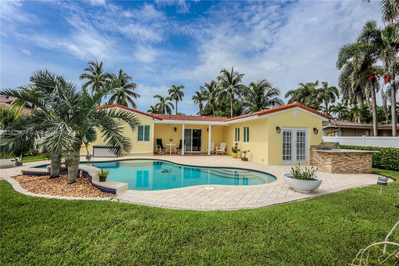 Stunning home in the heart of Hollywood Lakes. Beautifully renovated 3 bed, 2 bath, plus den/office or 4th bed. 2 houses away from South lake. Gorgeous new kitchen w/white shaker cabinets, quartz countertops, 36“gas range w/6 burners, SS appliances & more. Porcelain wood-like tile throughout & travertine in 2 bedrooms, custom closets, impact windows & doors, tankless gas water heater. Laundry room has new washer & gas dryer, quartz countertop, & built in cabinets. Enjoy a tranquil oasis w/saltwater pool & soothing waterfall, outdoor kitchen w/gas grill, fenced backyard with luscious landscaping. Circular paver driveway & pavers surrounding pool, tile roof, covered front & back porch, freshly painted, landscaping lighting, & sprinkler system. This meticulously maintained home has it all!