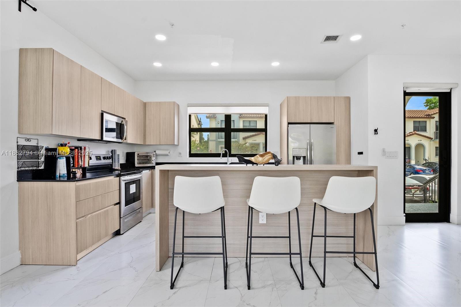 Step into this beautiful 3-bedroom, 2.5-bath townhome nestled in a highly desirable and peaceful Miramar community. From the moment you walk in, you’ll be greeted by a bright open-concept layout, featuring sleek porcelain tile floors and a modern chef’s kitchen with stainless steel appliances, contemporary cabinetry, and a spacious island perfect for entertaining.
Upstairs, retreat to your private sanctuary where both the primary and second bedrooms open to charming balconies—ideal for enjoying your morning coffee or a relaxing evening breeze. A full-size washer & dryer add convenience to your daily living.
Near Hard Rock Stadium, State Rd 7, I-95, the Turnpike, schools, parks, and shopping- combines style, comfort, and accessibility—making it an exceptional choice for modern living.