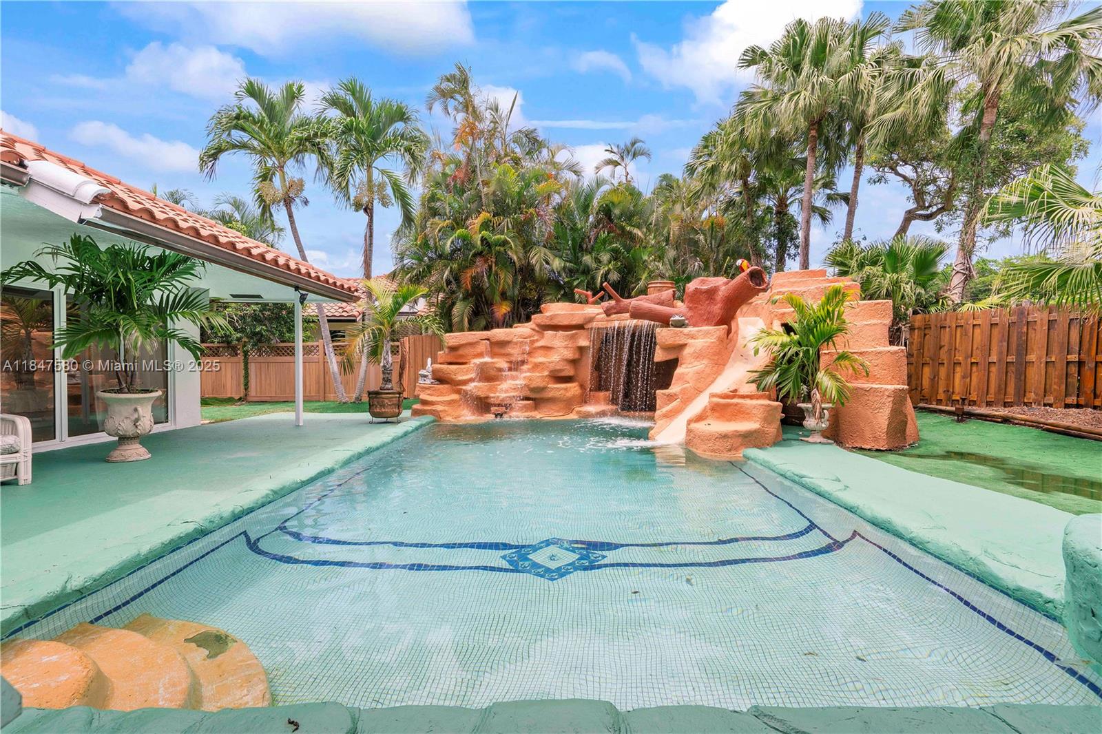 The most exciting and unique house you have ever seen! Exciting Resort style “Water Park” back yard with an amazing water slide, and huge incredible water falls, that cascade down a two beautiful rock walls.But wait!There is also a Pickle-ball/Tennis/Badminton Court with a basketball hoop court.Huge windows with views of this professionally landscaped tropical paradise with beautiful palm trees surround the whole house.Beautifully renovated all new bathrooms and the master bathroom has a Jacuzzi Jet spa tub.Virtually new stainless appliances including new LG extreme hi heat stainless stove and refrigerator stainless dishwasher,two microwaves and new LG washer and dryer. New A/C units 5 years ago and ducts cleaned New Hayward salt water treatment pool system and maintenance free landscape.