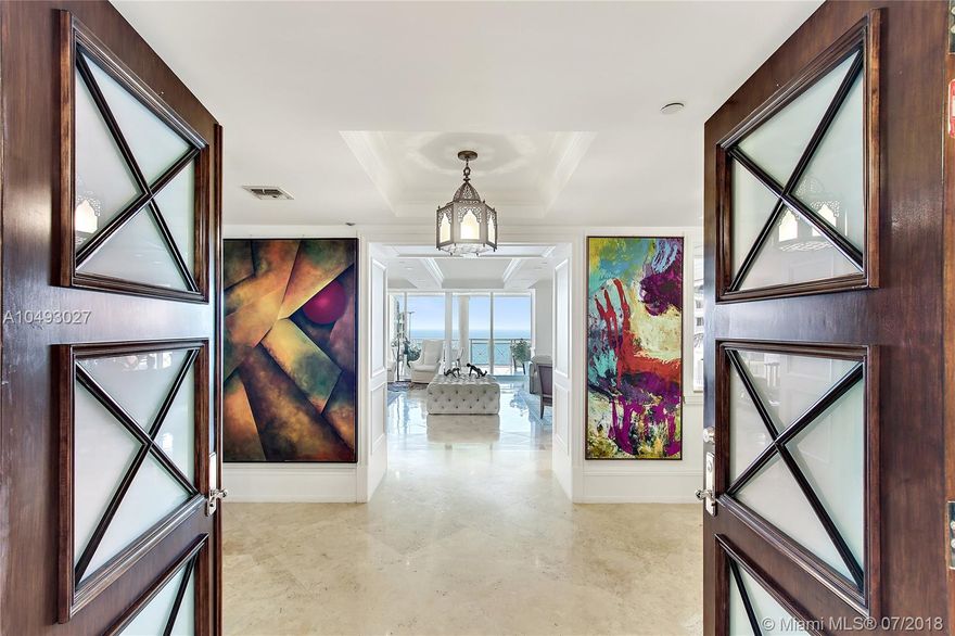 Presenting one of Grand Bay community’s largest luxury units with views of the Ocean and Bay. Just imagine 5634 int. SF, 5 bed, 4.5 baths, and beautiful terraces. A private elevator opens to the double size living room. An art lovers dream! Hector-Hector chef’s kitchen has center island breakfast bar, custom Chippendale cabinetry, top shelf appliances, three ovens and a wine fridge! Dinner can be served in the dining room next to the rustic Library, serving wine from the temperature controlled 1,100 bottle wine room. After a movie in the theater, retire to the Master suite with spacious walk-in closet, spa-like bath, for a soak in the tub. Draw the motorized shades, and enjoy the smart home entertainment system. Includes 2 parking spots, storage, and a 245 SF studio (1/1) on the 1st floor.