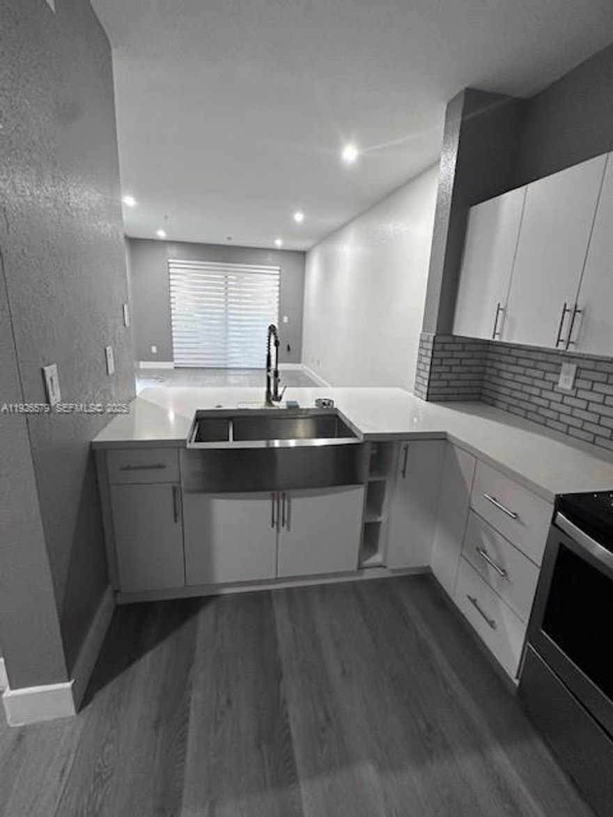 Beautiful corner unit, 2/2 condo. Located in the desirable Hialeah/Miami Lakes area, this property offers a spacious layout with large bedrooms, ample closet space, and an open-concept kitchen. Features include Laminated floor throughout, in-unit washer and dryer, and access to a clubhouse and community pool. Enjoy the convenience of an assigned parking space, plenty of guest parking.