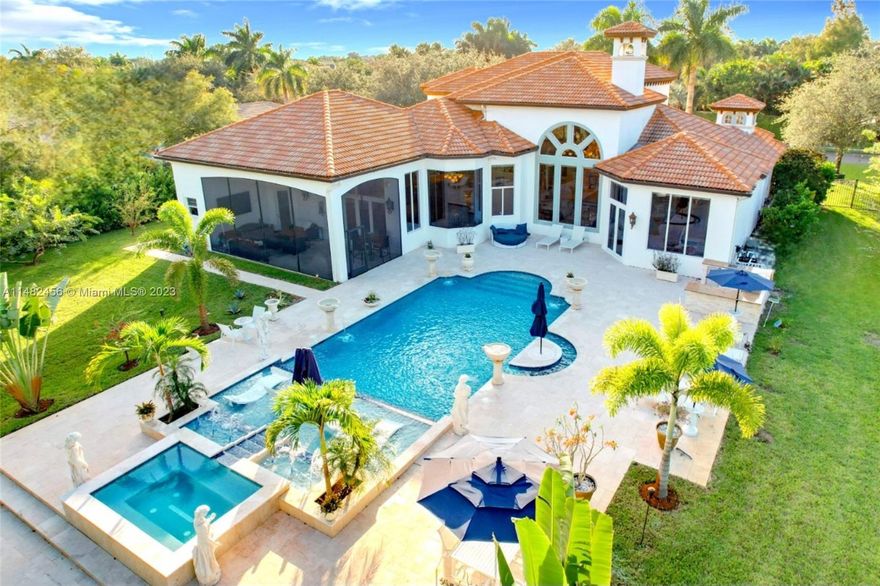 Nestled in Blackhawk Reserve, exceptional custom estate home. Circular driveway adorned with lush landscaping. 24-foot ceilings with floor-to-ceiling marble gas fireplace and Italian marble flooring. Magnificent chandeliers adorn the space. Gourmet kitchen with elite appliances, center island, exotic granite countertops, 8-burner gas stove with grill. First-floor owner's suite sanctuary of luxury, featuring sunken jacuzzi tub, floor-to-ceiling onyx, oversized shower. Additional living space in loft and den. Smart technology, motorized blinds, comprehensive security system, and speaker system. Fully fenced property with brand new 60 x 20 salt-heated pool and 15-person spa and summer kitchen on acreage property. Residents enjoy access to tennis courts. This residence embodies luxury living.