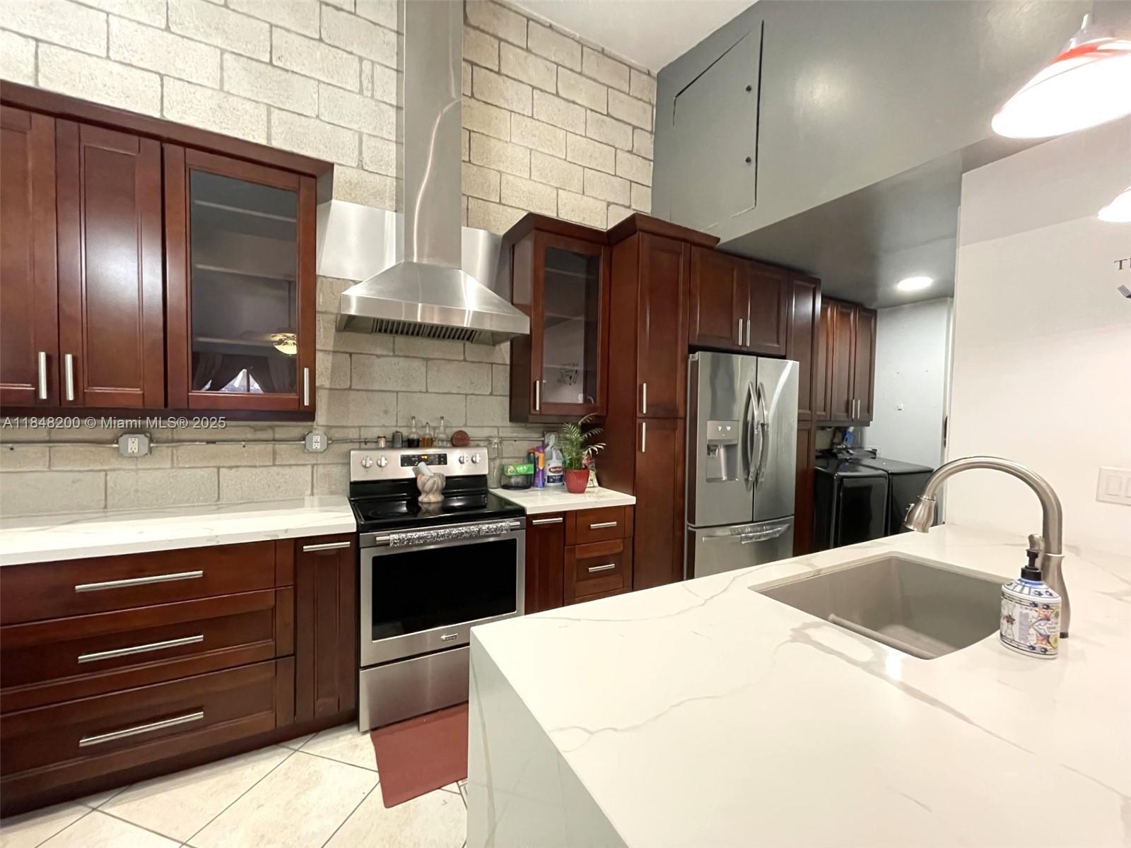Welcome to your corner Villa in South Florida. This 2 bedroom, 2 bath north facing Villa is upgraded with an amazing open kitchen and extended cabinetry with lots of storage, quartz counter tops, SS appliances and range hood, high efficiency washer/dryer, tankless water heater and upgraded bathrooms. It offers you an open concept living area for maximum enjoyment and entertainment that leads to the private patio with wooden fence. The exterior plastic shed stays. Also features a brand New AC, tile in living areas and bathrooms, laminated flooring in bedrooms. Enjoy the peace and quiet while being minutes away from the Sawgrass Mall, major highways and within walking distance to Welleby elementary school. The community offers a Pool and 2 assigned parking spots. LOW ASSOCIATION FEE!