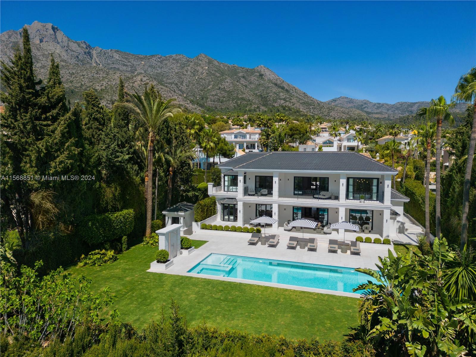 Property is located in Marbella, Spain. Villa Dafne in Sierra Blanca offers a luxurious stay with breathtaking Mediterranean views. Nestled at La Concha’s foothills, this villa sleeps 12, featuring a seaside charm, open-plan living, and elegant wooden floors. Outdoors, enjoy a spacious area with a stunning pool and covered terrace for al fresco dining. It boasts luxurious amenities like an indoor pool, sauna, and gym. With six double bedrooms and ensuite bathrooms, it promises privacy and comfort for families or friends.