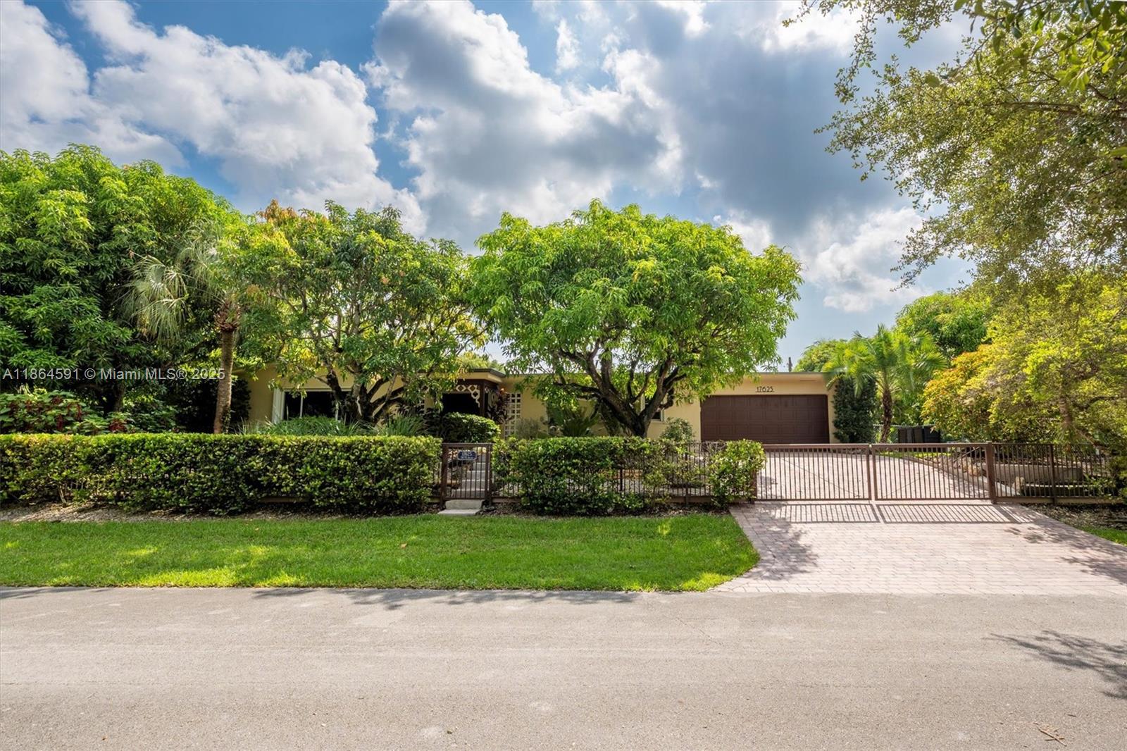 No HOA!! Not Flood Zone (X), 2019 Main House Metal Roof & Solar Panels. Garden Paradise in over 1/2 acre of land (25,200 sqft), Mango, Avocado, Lychee, Longan trees to enjoy nature privately. Beautiful 1-story house, 3 bedr./2 bath in Main House (3rd bedr. currently open office). Separate Guest House or In-Law Quarters with 1 bath & living room. Both structures built around a 6 Foot Saltwater & Heated Pool, screened w/outdoor sitting area & quartz counter extending from kitchen into pool area to enjoy with family. Remodeled kitchen with cathedral ceiling, quartz counter tops, SS appliances, 3 tier lighting, 2 garage, auto sprinkler, impact glass main house, accordion shutters double protection, wood carved front door, 2022 A/C, space for boat. Great Schools & Close to Palmetto Bay Park.