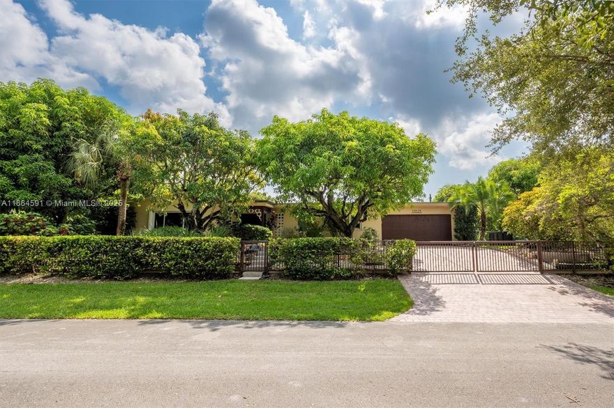 No HOA!! Low Taxes & Not Flood Zone (Elevation 13 Ft.)  Private Garden Paradise with over 1/2 acre lot (25,200 sqft), Mango, Avocado, Lychee, Longan trees.  Beautiful 1-story house, 3 bedr., 2 bath, plus 1/1 separate Guest House or In-Law Quarters with living room.  3rd bedr. currently used as open layout office.  2019 Main House Metal Roof & Solar Panels. Both structures built around a 6 Foot Saltwater & Heated Pool, screened w/outdoor sitting area & quartz counter from kitchen into pool area to enjoy & relax.  Gorgeous kitchen with cathedral ceiling, quartz counter tops, SS appliances, 2 garage, auto sprinkler, well irrigation, impact glass main house, accordion shutters double protection, wood carved front door, 2022 A/C, space for boat & RV. Great Schools & Close to Palmetto Bay Park.