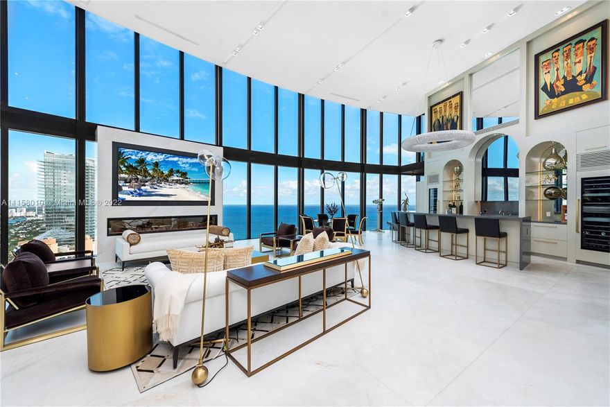 Ultra-high-end oceanfront residence finished with a selection of the finest materials, excellent 2-level floor plan, and panoramic ocean & intracoastal views! Designed to perfection with custom-made luxe upgrades, this condo has a living room with soaring 22-foot ceilings, floor-to-ceiling wet bar, & a custom 100-inch Sony-TV. Mia Cucina kitchen with Bouche appliances opens to a family room, second-level recreation room, extravagant master with 2 baths, walk-in closet, & an office/gym. Exquisite 48x48 marble floors flow throughout, Lutron lighting & shades, Ornare closets, Savant system. Indulgence continues outside the 2 terraces equipped with a mosaic-tile pool, summer kitchen, dining, & lounging areas. Additional private elevator & an attached 4-car garage completes this dream home.