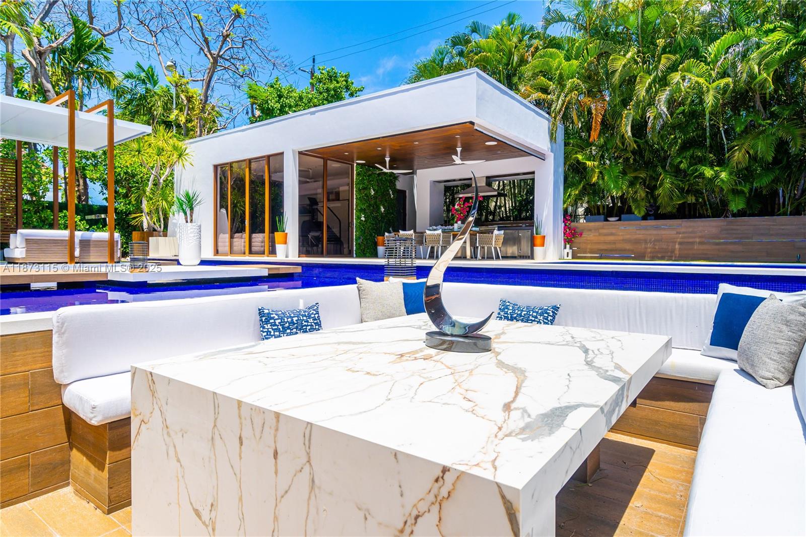 Exquisite modern residence is a stunning expression of contemporary luxury in one of Miami Beach’s most exclusive neighborhoods. Spanning 5,119 SF + 14,300 SF lot, home features 5 beds/5.5 baths & open, light-filled design w/ bespoke detail throughout. Great room is framed by floor-to-ceiling glass, seamlessly connecting to lush landscaping by Lewis Aqüi. Marble & quartz flooring on the 1st level transition to warm oak upstairs, complemented by elegant Delta lighting. Snaidero kitchen w/ Miele appliances, double ovens + sleek cabinetry. Spaces include office, den, pool house + gym. Outdoors, shimmering pool, summer kitchen & dining areas provide the perfect setting for entertaining. The home’s refined aesthetic is enhanced by Prodema cladding, while a full-house generator adds convenience.
