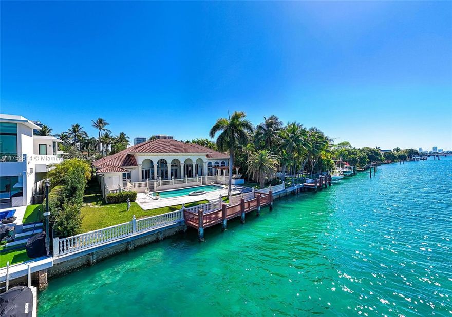 Tucked away in a private cul-de-sac, this Mediterranean estate offers over 100 feet of prime waterfront with breathtaking, bay views. The 7,000 SF residence is designed for privacy, featuring a grand circular driveway, no front-facing neighbors, and a serene, exclusive atmosphere. Nestled across from a lush green park, the home enjoys a rare balance of bay vistas and natural beauty. Located in one of Miami’s most prestigious gated communities, residents enjoy access to a private marina, with Bal Harbour Shops just a short walk away. The property also includes Kobi Karp-designed plans for a striking 12,000 SF modern estate, presenting a rare opportunity to either enjoy the existing home or bring a visionary new build to life.