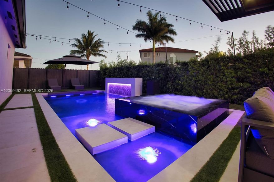 A truly rare offering—this impeccably upgraded residence offers approximately 1,960 total square feet and delivers a level of design and finish seldom found in the area. The showstopping backyard rivals resort-style living, featuring a stunning custom pool and spa with dramatic lighting and water features, complemented by a sleek pergola, built-in outdoor kitchen, and a fully integrated entertainment space. Inside, the home continues to impress with thoughtfully curated upgrades, including a designer kitchen with custom cabinetry, a striking glass-enclosed wine display, and spa-inspired bathrooms with modern finishes throughout. Every detail has been carefully considered, creating a move-in ready home that blends style, comfort, and functionality. A one-of-a-kind opportunity for buyers seeking exceptional quality and a home that truly stands apart.