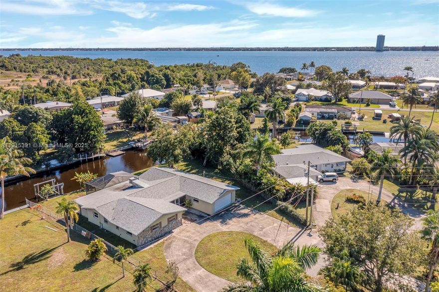 Experience relaxed Southwest Florida living in this single-level pool home on a 0.31-acre canal lot with direct access to the Caloosahatchee River and Gulf. The bright, open layout includes an updated kitchen with large island, granite counters, and stainless-steel appliances. The primary suite offers a sitting area with lanai access and a private ensuite bath. Two additional bedrooms provide flexibility for guests or workspace. Outdoor living features a covered lanai, therapeutic pool, above-ground hot tub, mature landscaping, and a tranquil canal backdrop. A two-car garage, no HOA, and a quiet neighborhood close to shops and dining add to the appeal. A great opportunity for waterfront living with easy boating access.