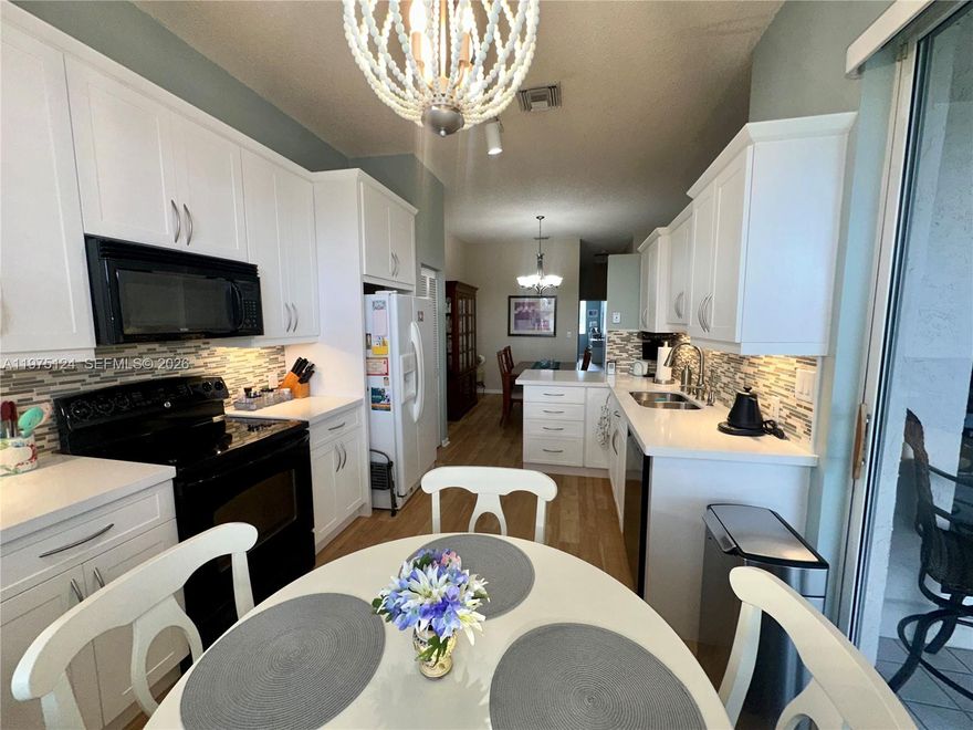 This large 3/2 condo, with a garage, 1,650 square feet, and stunning lake view, is in the desirable Grand Palms gated community in West Pembroke Pines. This very well-maintained unit features in unit laundry room, upgraded Luxury Vinyl Flooring, Kitchen, and Bathrooms,  Accordion Shutters, 2024 AC, and 2014 Water Heater. The only bill the owner pays is FPL and Condo fee, which includes Internet, Basic Cable, Alarm, water, sewer, trash, exterior insurance, Guard Gate,  New Roof, and community amenities, ensuring a hassle-free lifestyle. Chair lift included. Enjoy peaceful lake views from your home while living in a secure, well-kept community with excellent amenities.