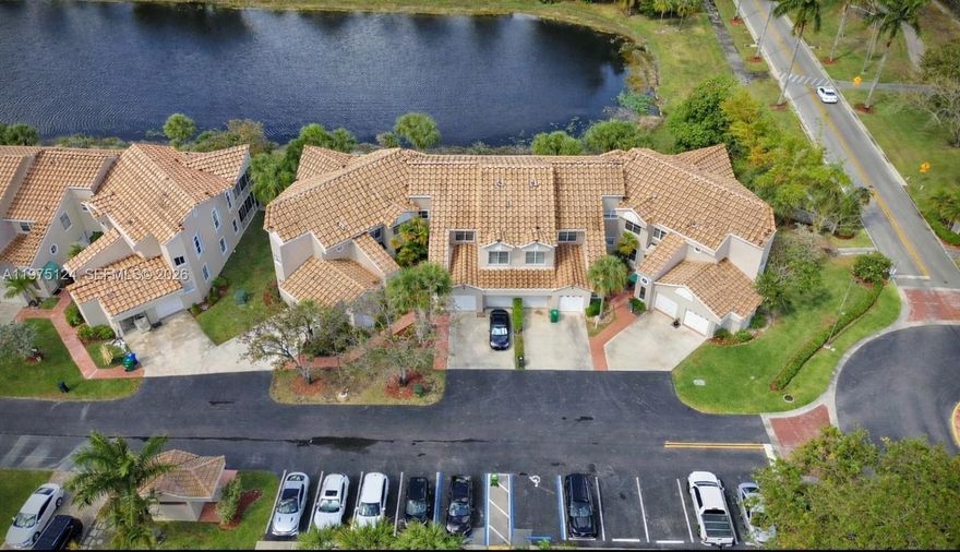 This large 3/2 condo, with a garage, 1,650 square feet, and stunning lake view, is in the desirable Grand Palms gated community in West Pembroke Pines. This very well-maintained unit features a unit laundry room, upgraded Luxury Vinyl Flooring, Kitchen, and Bathrooms,  Accordion Shutters, 2024 AC, and 2014 Water Heater. The only bill the owner pays is FPL and Condo fee, includes Internet, Basic Cable, Alarm, Water, Sewer, Trash, exterior Insurance, Exterior Pest Control, Guard Gate,  New Roof, exterior painting, community amenities, ensuring a hassle-free lifestyle. Chair lift included. Enjoy peaceful lake views from your home while living in a secure, well-kept community with excellent amenities. No assessments.