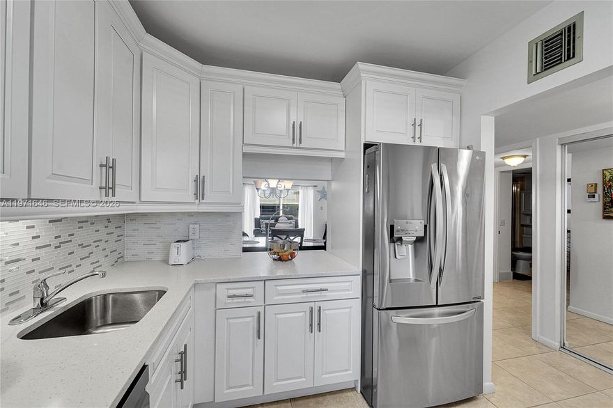 Just Gorgeous! Stunning 2-bedroom, 2-bath condo in desirable Oriole Gardens Two, a well-maintained 55+ community. Offering over $60,000 in upgrades, this beautifully updated unit features a remodeled kitchen with stainless steel appliances, updated bathrooms by Bath Fitter, recently painted interior, and tile flooring throughout. A/C replaced April 2025. Hurricane impact windows and sliding door provide added protection and peace of mind. Walk in closet.  Clean, bright, and completely move-in ready. New roofs are currently being installed. Enjoy resort-style amenities including an active clubhouse with social activities, fitness options, and a beautiful community pool. Ideally located within walking distance to shopping, banks, restaurants, and everyday conveniences. Don't miss this beauty!