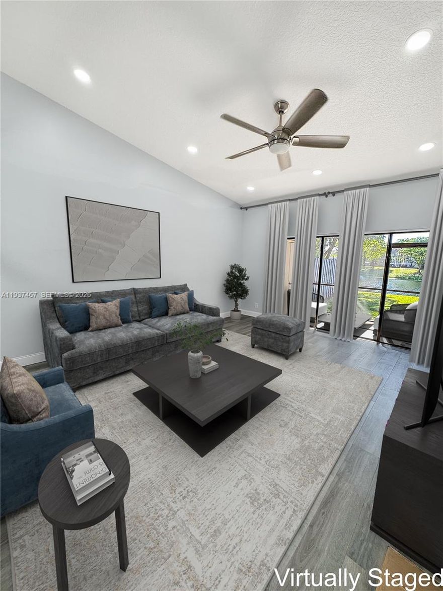 Beautiful WATERFRONT 2 bedroom 2 bathroom with open floor plan in an  ALL AGES, PET FRIENDLY community.  This property has the feel of a single family home with your own private driveway and front yard. HURRICANE protection on all windows. AC 2021 HW Heater 2020. Both bedrooms have en suite bathrooms.  Plenty of space in the large walk- in closet in the primary bedroom.  Luxury vinyl floors throughout and upgraded high hat lighting for a bright and cheerful living space.  Enjoy the peaceful water views from your private backyard.  Additionally, you have a screened in patio with laundry closet and another closet for storage.  Minutes to I95 & Turnpike. Close to shopping.