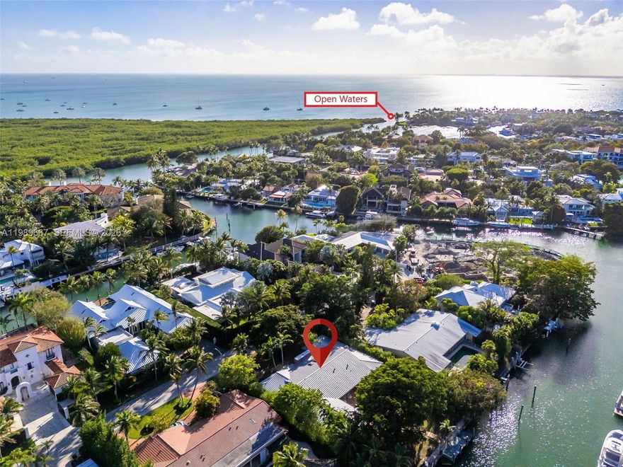 Rare opportunity to own a 16,000 sq ft waterfront lot on one of Key Biscayne's most coveted cul-de-sacs. Nestled on a quiet, no-traffic street, this lovingly maintained residence offers an exceptional combination of location, lot size, and livability rarely found on the island. With 100 feet of direct water frontage and no fixed bridges to open water, the property is a boater's dream, simply step onto your private dock and cruise around the corner to Boater's Grill, The Cleat for lunch or sunset cocktails or out to the bay! The home's thoughtful positioning creates a generous setback from the water's edge, yielding a beautifully manicured backyard that is a true rarity on Key Biscayne. A mature mango tree anchors the lush landscaping, while the deep lot provides the kind of outdoor space that simply does not exist on most waterfront properties here. Inside, the home is bathed in natural light and flows effortlessly. The open kitchen connects seamlessly to the family room, creating a warm, inviting gathering space at the heart of the home. The ideal floor plan places the primary suite, with dual his-and-her bathrooms, on one wing alongside three additional bedrooms, while a separate guest suite ensures privacy for visitors. Impact windows and doors throughout. Two-car garage. Offered in excellent condition. 221 Knollwood Drive represents the best waterfront value on Key Biscayne. Opportunities of this caliber are exceptionally rare.