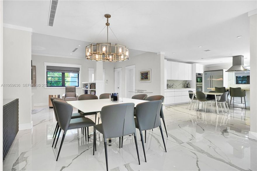 This light and bright, fully renovated 4-bed, 3-bath home offers an open-concept living space. Featuring porcelain floors throughout, hurricane impact windows and a new metal roof. The gourmet kitchen features a Carrara island, two sinks, Bosch appliances, and a Viking fridge-freezer. The spacious primary suite includes his/her walk-in closets and a luxurious spa-like shower. A fourth bedroom has been converted into a study. The private outdoor space is perfect for entertaining, with a heated pool, redone pavers, and lush landscaping. Additional upgrades include a security system and freshly painted interior and exterior. Move-in ready with no detail overlooked!