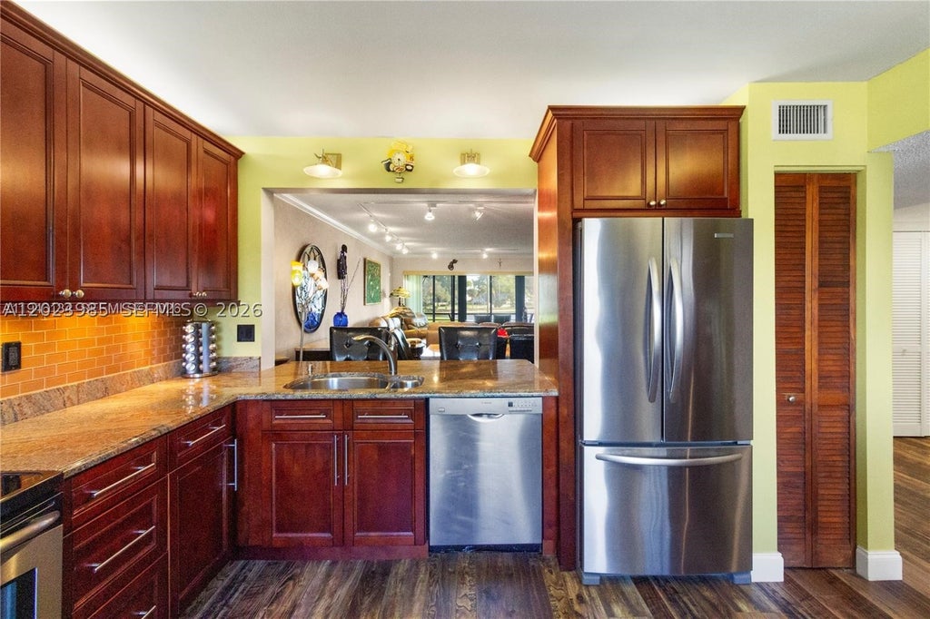 Photo of 5519 Fairway Park Dr #203, Boynton Beach, FL 33437 (MLS # A12023985)