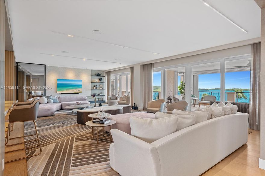 THE EPITOME OF LUXE LIVING WITH BREATHTAKING MIAMI SKYLINE & OPEN BAY VIEWS THIS FISHER ISLAND RESIDENCE IS CURATED BY RENOWNED DESIGNER CARLA CANEPA! Turn-Key Home where every detail has been Crafted to Perfection w/Sierra Italian furnishings. Spacious 5-Bedrooms + Office, 5.5-Bath offers 6,120 SF of refined interior living space. Expansive terraces w/Sunset Views. Listone Giordano Italian Light Oak Wood Floors, Chef's Kitchen w/Double Premium Wolf Appliances. Bar area w/Polished Onyx Bar & Temp Controlled Wine Room. Powder Room in Blush Onyx. Expansive Primary Bedroom Suite w/separate Walk-In Closets & Primary Bath wrapped in Exotic Book-matched Slab Stone + Soaking Tub w/Matte Gold Dornbracht fixtures. Impact Glass Doors & Lutron & Sonos. AC Storage. 2 Parking Spaces + XLGolf Cart Space