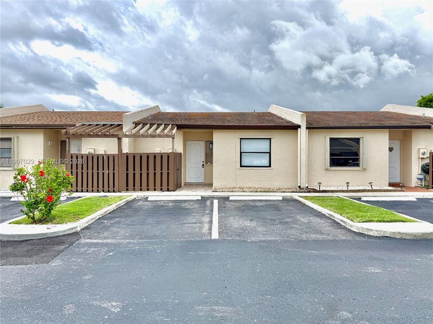 This 2/2 villa features a 2019 roof and an open layout bright with natural light, featuring fresh paint and waterproof, scratch-proof vinyl flooring throughout. The kitchen is equipped with stainless steel appliances, white cabinetry, Calacatta Quartz countertops, a pantry, and a huge counter perfect for gathering. Both bathrooms include porcelain tile and quartz finishes, with a walk-in shower in the primary and a soaking tub in the second bath. Storage is plentiful with a walk-in closet in the primary suite, a large closet in the second bedroom, and an attic. Outside, you'll find a private fenced-in patio and two dedicated parking spaces directly in front. Located in a well-maintained, central community with very low HOA fees, no rental restrictions, pet friendly, a 2024 water heater, and hurricane shutters, this home is move-in ready.