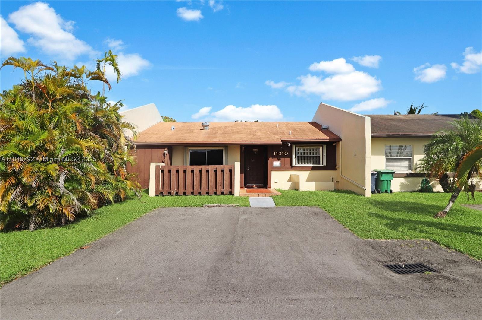Discover this spacious townhome-villa in the sought-after Devon-Aire community. This home offers a spacious layout with vaulted ceilings, rustic tile floors in the main areas, and carpet in the bedrooms. For added peace of mind, the property comes equipped with hurricane shutters. The large main bedroom is a true retreat, with a large walk-in closet and private access to the back patio. The home is equipped with an ample kitchen, a convenient laundry area, and a large pantry. Enjoy the convenience of private parking, with additional guest parking available. With a very low HOA, its prime location places you just minutes from shops, restaurants, schools, the Florida Turnpike, Palmetto Expressway, and other main roads, offering an ideal blend of serenity and convenience.