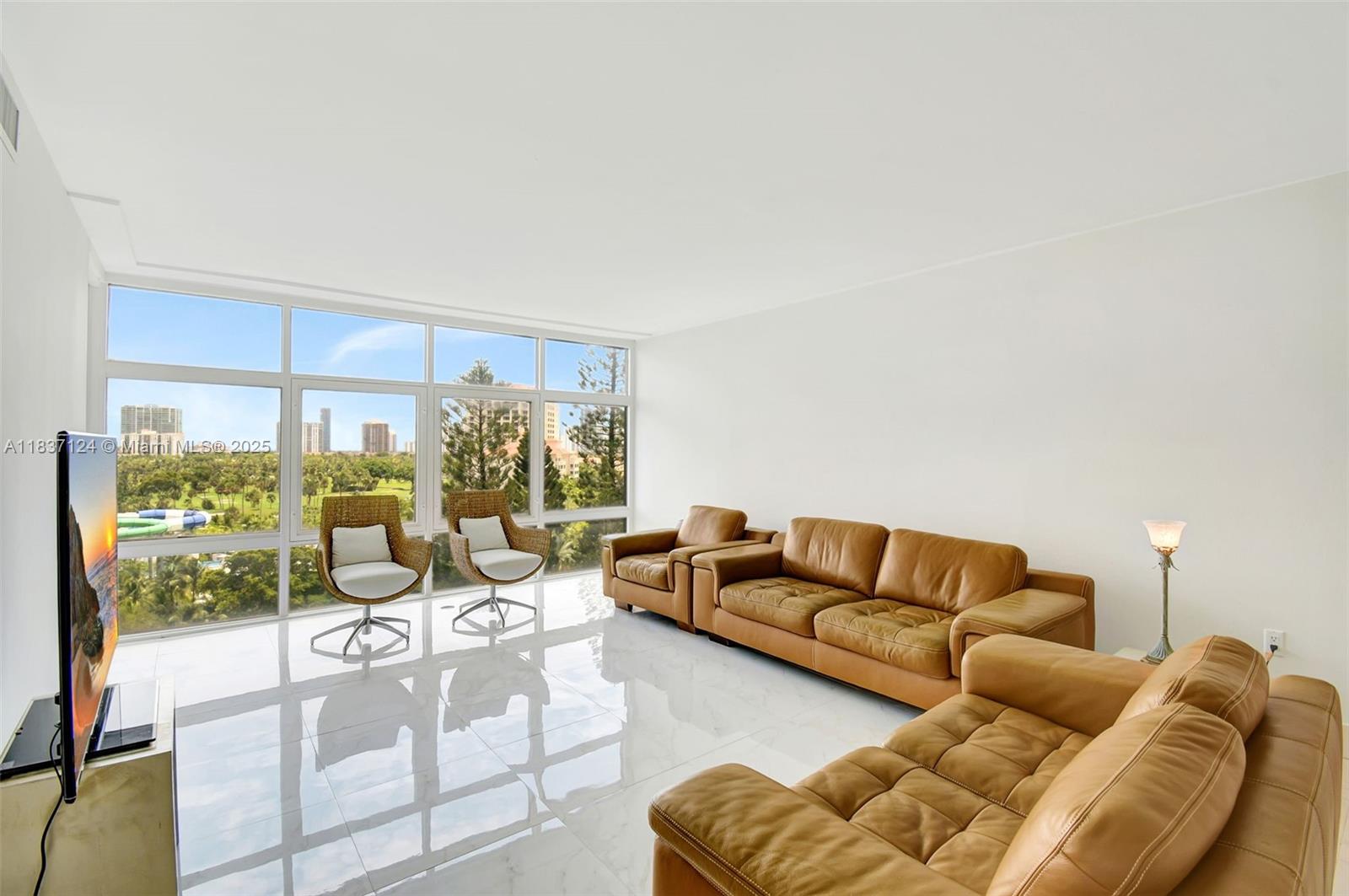 Bonavida Condo / Aventura / Corner unit / 1,308 sq. ft. of living area / 2 Beds plus additional room that can be used as a walk-in closet, an office, or a den / 2 Baths / Majestic views of the Turnberry Isle golf course and Sunny Isles Beach in the background / Bonavida condo amenities: swimming pool, gym, billiard table, club-room, onsite management office / Walk in the 3-mile path around the golf course, just steps from the building / Across the street there is a plaza, featuring a supermarket, pharmacy, restaurants, and access to Aventura Mall / Short distance to the Waterways Plaza, Marina, Beaches, Gulfstream Casino, Universities, Hospitals & many other places of interest.