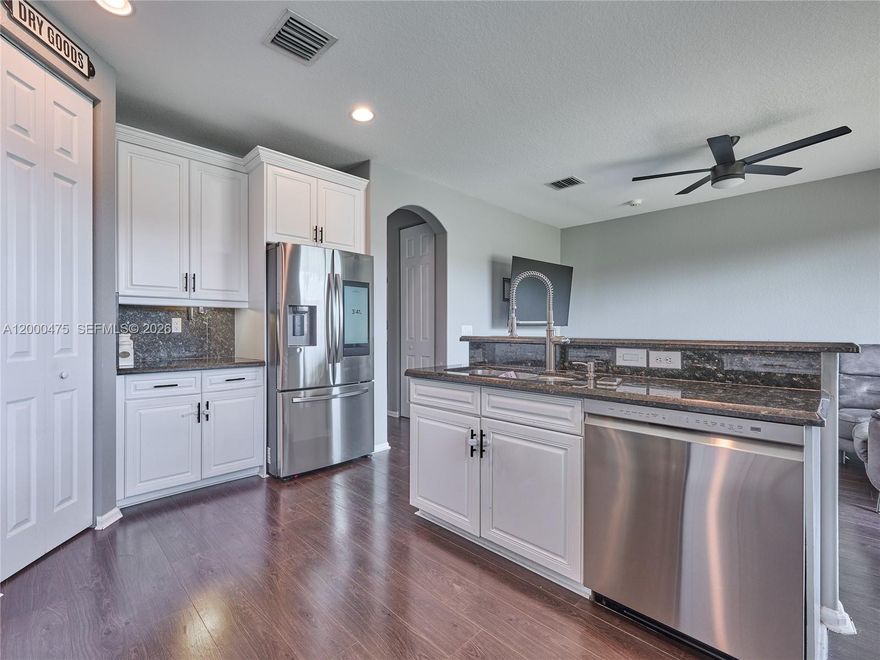 Spacious and move-in ready, this 4-bedroom, 3.5-bath townhouse offers stylish vinyl wood-look flooring throughout with no carpet and a newer A/C for added comfort and value. The open-concept kitchen features granite countertops and stainless-steel appliances, seamlessly flowing into a bright dining area with access to a private patio overlooking a peaceful lake. Located in a highly desirable, centrally situated community with resort-style amenities, including a heated pool, tennis and basketball courts, fitness center, playground, BBQ areas, and more. Zoned for A+ schools and just minutes from premier shopping, dining, and everyday conveniences. Investors welcome—rent immediately. Pet-friendly community. HOA resale capital contribution is $2,000. HOA includes roof, exterior maintenance, common areas, ADT security, and full access to amenities. Ideal for homeowners and investors alike.