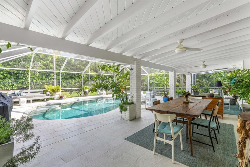 Impeccably updated and thoughtfully designed one-story 3-bedroom, 2-bath residence in a wonderful neighborhood. Upgrades include a Tesla solar panel system with backup batteries, solar water heater, new AC, and fully renovated bathrooms. Refined marble and wood floors flow throughout, complementing the high-end eat-in kitchen with custom cabinetry and a wall-to-wall storage unit. Step into a resort-style backyard—an exquisite screened-in pool oasis with jacuzzi, oversized covered terrace, and lush tropical landscaping, perfect for both relaxing and entertaining. Additional features include a impact doors and windows, newer roof, paver driveway, dual storage areas, and a prime location near top-rated private and publics schools and the Deering Estate.