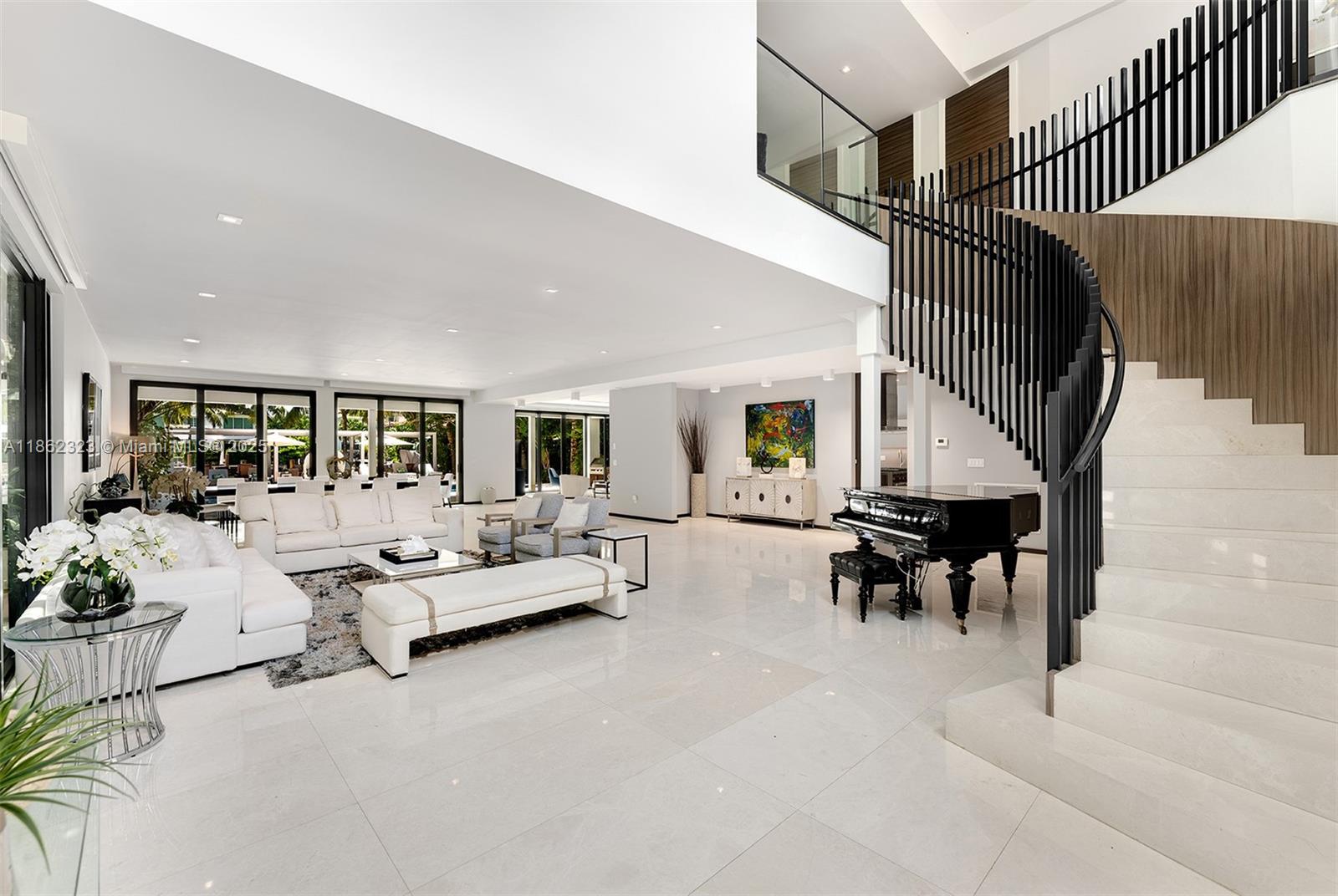 This fully furnished 8-bedroom, 9-bath estate exudes timeless elegance and modern sophistication. A gated driveway opens to a grand foyer, leading to sun-drenched living spaces accentuated by sleek wood finishes, soaring ceilings. Designed for resort-style living, the property features a heated pool, private dock, and a fully equipped outdoor kitchen ideal for entertaining guests. The primary suite is a tranquil waterfront sanctuary with a spa-inspired bath and sweeping views, while expansive open-plan interiors effortlessly connect indoor comfort with outdoor leisure. Ideally located in Miami Beach, just minutes from Sunset Harbour, premier dining, and quick access to I-95, this estate offers the perfect combination of privacy, convenience, and luxury.