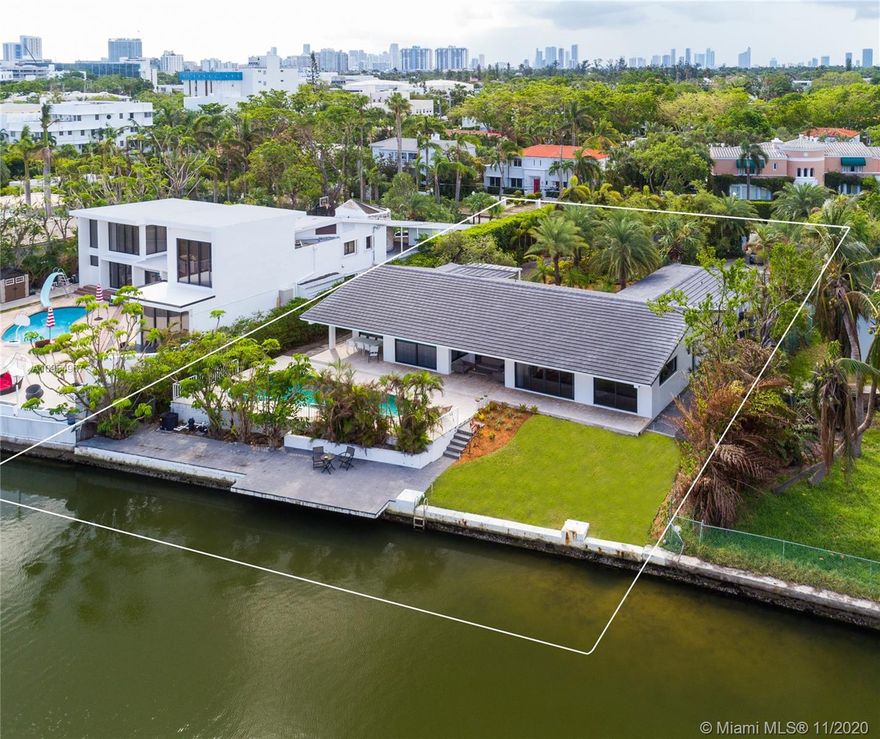Best waterfront deal in Miami Beach! Beautiful mid-century style home situated on a huge 18,298-sf lot with 100-ft of waterfront, minutes to the beaches and Lincoln Road mall. This one-story 1974's home has a new roof from 2017, impact doors and windows, expansive open-concept living areas, modern kitchen with a cooking island, 3 large waterfront bedrooms, walk-in closets, 2-car garage, and polished concrete floors. Gated and secluded with lush landscaping, this property has a circular driveway that can accommodate many cars and a waterfront backyard with a freeform pool and a dock. Easy rental for income-producing while designing and permitting for building a new home. At the $3.95M, this waterfront is close to land value.