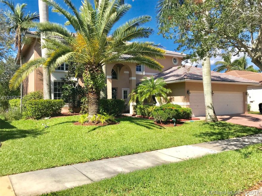 Highly upgraded 5 bedroom 4 full bath model condition property on a beautiful private lake with no neighbors behind.  Pride of ownership with all baths completely renovated in marble backsplash, soaring 2 story living room entrance with light wood floors, neutral colors, contemporary style kitchen with white wood and glass cabinetry, stainless steel appliances, breakfast table nook, center island, upgraded closet doors, all wood flooring throughout upstairs and downstairs.  Nothing to do but move right in as its all been done! Accordion shutters. French doors to pool and patio.   Run to this one!