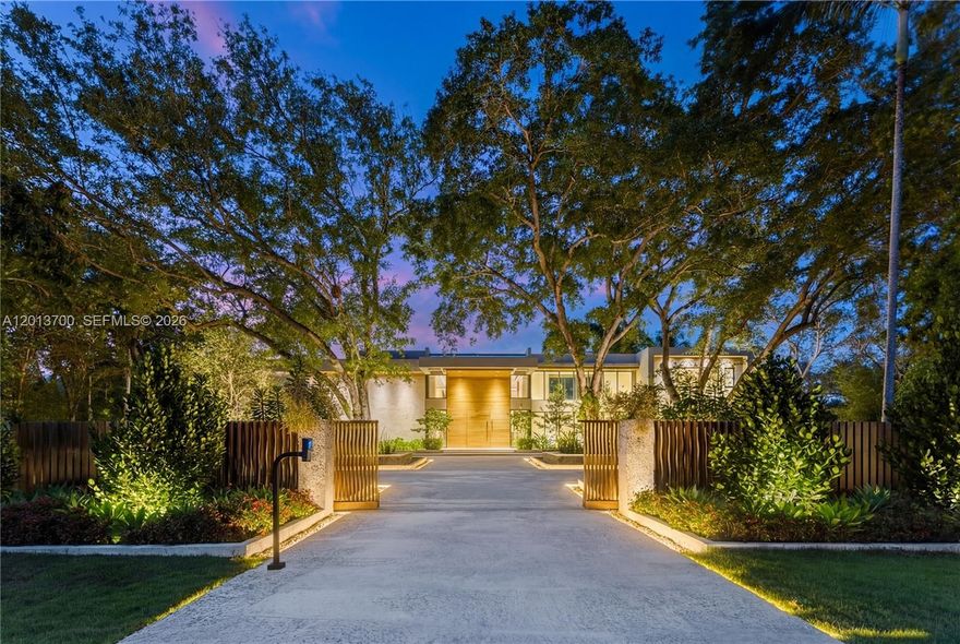 Crestpoint Estate represents a rare convergence of architecture, resort-scale amenity and artistic vision, privately set behind a parametric entrance on a 55,000+ square foot estate in the heart of Pinecrest. Spanning over 16,000 total square feet, the residence offers 7 bedrooms and 8.5 bathrooms, defined by a refined palette of oolite stone, cumaru wood, and venetian plaster.
A dramatic, LED-lit entry court sets the stage for arrival, leading to a grand double-height foyer anchored by a sculptural walnut floating staircase. Natural light defines the interiors, highlighted by a signature sloped skylight over the great room and a glass-lined corridor framed by lush tropical gardens, seamlessly blending indoor and outdoor living.
The Fendi-designed kitchen overlooks the expansive grounds, while the formal living and distinguished entertainment room features bespoke Hermès leather accents. Outdoors, a double-height cascading granite waterfall as a striking focal point alongside a sunken fire lounge, Sukabumi stone pool, putting green, and curated landscaping. Furnished by Artefacto, Crestpoint Estate offers a warm, fully turnkey residence designed for refined entertaining and everyday living.