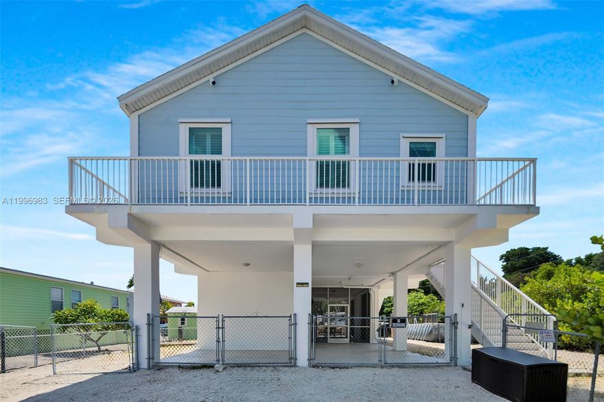 FLORIDA KEYS LIVINGT AT ITS BEST!! Truly a Tropical Oasis, this Stunning 3 Bedroom 2 Bath Key Largo Canal Front retreat on a large corner lot with 65 feet of concrete dock & quick access to the Bay and Ocean thru Adams Cut will impress!! This 2006 impeccable home, with all the modern luxuries you could want, features gorgeous engineered wood floors throughout. The open living area is beautifully presented with soaring vaulted ceilings, a huge kitchen island for family gatherings! SS appliances and an induction cooktop. Step into your main bedroom and enjoy the moment in a spa like bathroom where you can unwind and relax. Downstairs you will find a very large patio area under cover perfect for Sunday BBQ's with friends and family. Enjoy the above ground pool with a spacious deck to cool off in. The 65' concrete dock is equipped with a 15,000 lb boat lift just waiting for a new boat! Plenty or room for all your water toys here! Bring your RV, there is plenty of room, this is a large 65 X 100' corner lot. Location! Location! Conveniently located in Lake Surprise, MM 106 Bayside. Absolutely one of Key Largo's premier neighborhoods, close to shopping, amazing restaurants and outdoor water fun. A 20 minute drive to the mainland makes this home  a perfect choice for those seeking the best of both worlds! Long Key Road is the first canal in from Blackwater Sound, you'll be out on the water in seconds. Don't miss this opportunity to own this stunning canal front home in Lake Surprise.