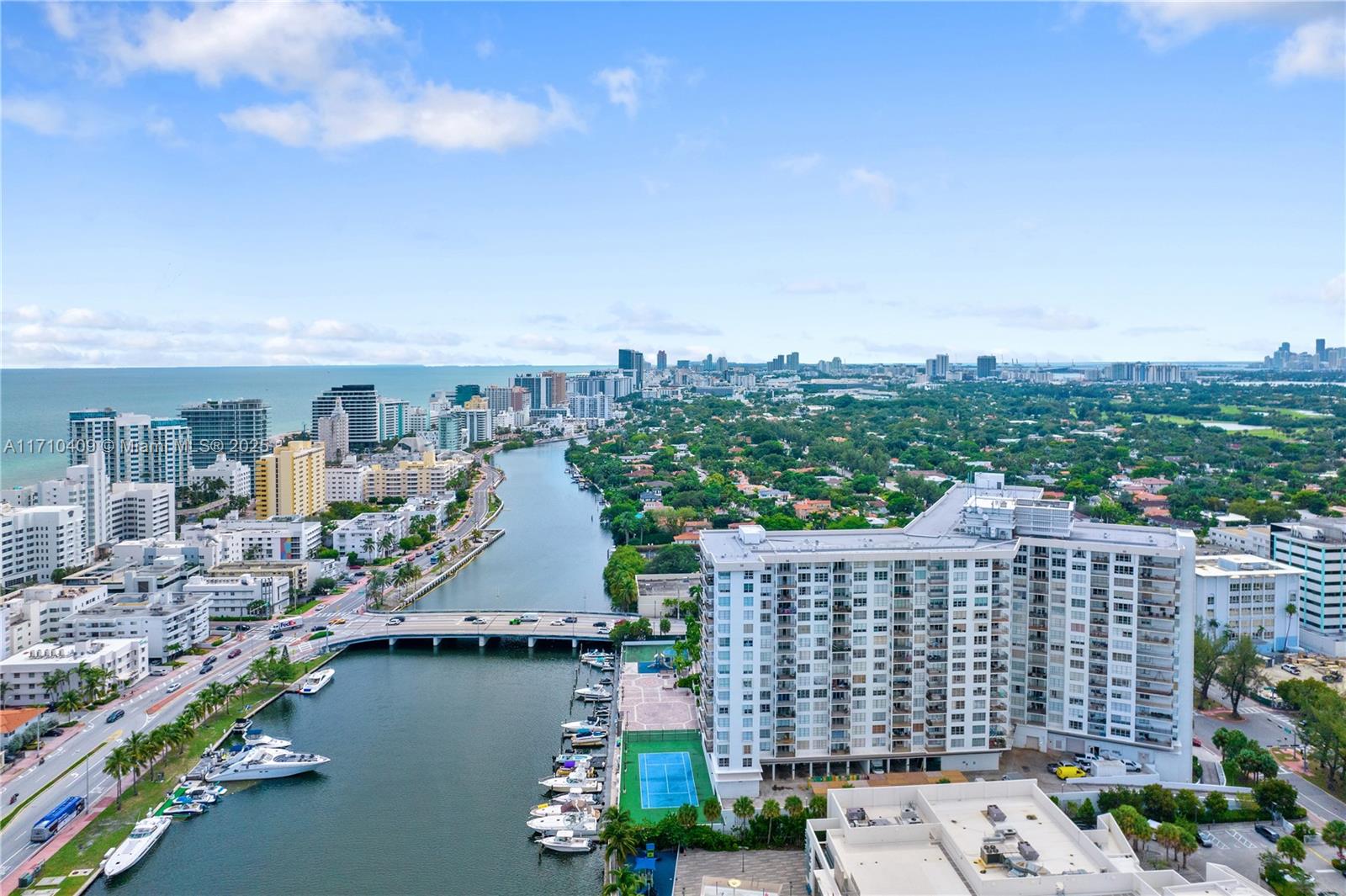 Elevate your lifestyle in this renovated, expansive residence on coveted Pine Tree Drive, where two units have been combined into one exceptional home. This unique property offers sweeping views of the bay and downtown Miami. Porcelain tile flooring and an open-concept layout create a bright, flowing space across the living, kitchen, and dining areas. The gourmet kitchen features a large island and ample cabinetry. A marble accent wall defines the dining area, while the living room opens to an expansive porch with ambient LED lighting. The primary suite boasts panoramic views, a walk-in closet, and a spa-like bath with a jacuzzi tub and jet shower. One bedroom includes a private porch, and another offers a separate entrance with a compact kitchen—ideal for guests or extended stays.