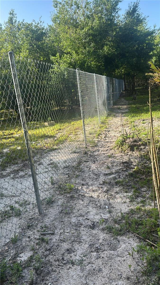 GREAT OPPORTUNITY! Discover 1.25 fenced acres with a gate. Fully enclosed per legal requirements. The land has been improved with a 18"x 30' Culvert at the entrance for easy acces. The power pole is located in front of property. Ideal to building a home, a weekend retreat, or an investment, this flat, almost clean and easily accessible lot offers endless possibilities. Proximity to Lake Okeechobee’s renowned fishing, boating, and outdoor activities while still having access to local amenities. The area is growing, making it a smart investment. Verify utilities and zoning for your plans. Accessible via NW 272nd St, this property provides space, privacy, and future value. Don’t miss out—own your piece of Florida’s rural charm today!