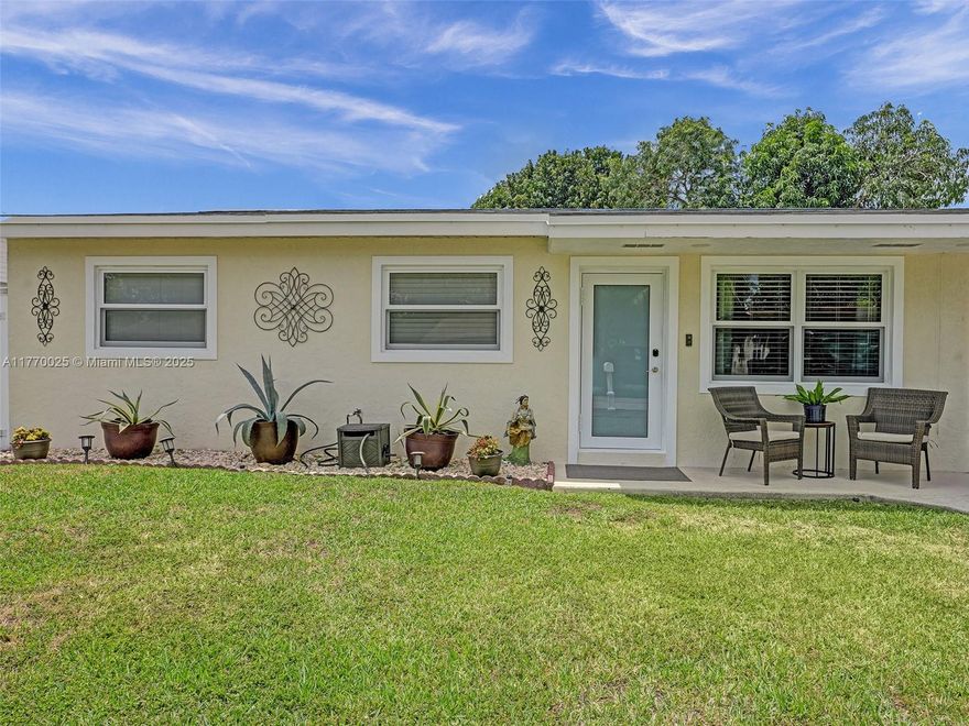 This charming 3/2 home is located on a peaceful, non-flooding cul-de-sac. The property boasts a modern kitchen with ample cabinetry, granite countertops, and stainless steel appliances, along with updated bathrooms and tile flooring throughout. The spacious bedrooms provide plenty of room, and there's a separate laundry room. For added convenience, there's a 1-car carport that can easily be converted into a 4th bedroom or office space. The home is ideal for family gatherings and entertaining, featuring a generously sized screened-in patio, a large fenced backyard with mature fruit trees, a shed, and an outdoor kitchen setup. Rest easy knowing that all major utility wiring, including FPL, Comcast, and AT&T, is underground, offering peace of mind during storms. This home is truly a must-see!