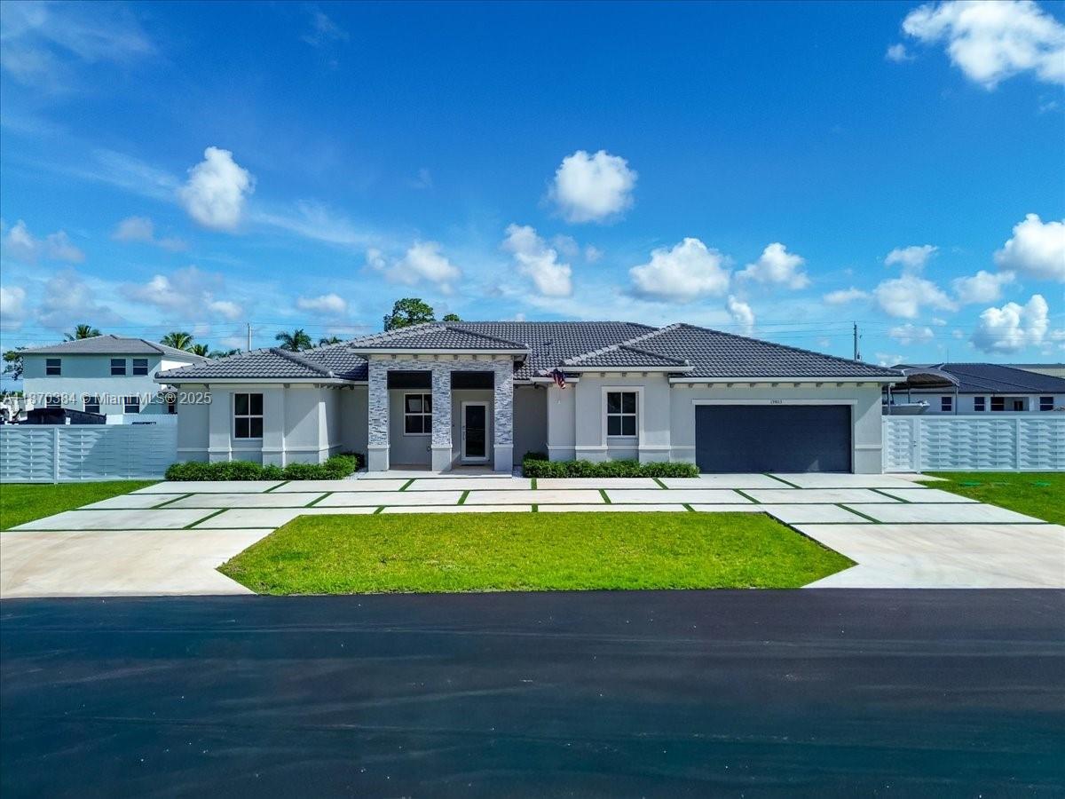 Built in 2024, this stunning 5BR/4.5BA home offers 3,257 adj. sq. ft. of modern living. Features include a foyer grand entry, open floor plan with large modern kitchen, bright white cabinets, quartz counters, top of the line stainless appliances. Large family room, living room and dining area. Spacious primary suite boasts walk in closet and spa-like bath. Interior laundry with easy access. Enjoy entertain inside our outside under a covered summer kitchen with full appliances and bar seating. Privacy fenced backyard and large storage shed. Extra features include a large canvas covered boat or RV storage and expansive concrete side area for additional parking. Beautiful curb appeal entrance with concrete circular drive with artificial turf. Located in a quiet neighborhood.