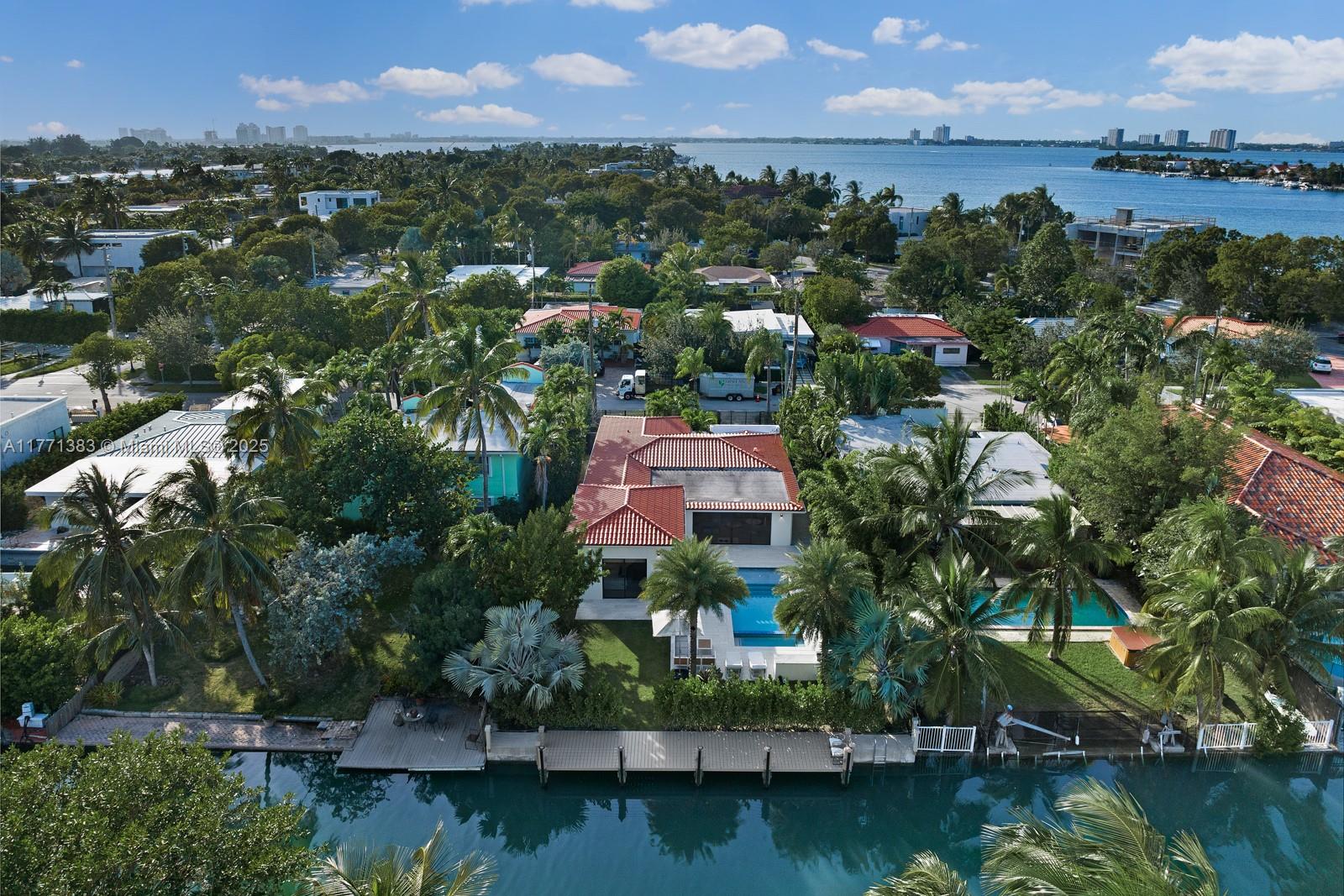 This exceptional turnkey home in the exclusive gated island of Biscayne Point was recently renovated and offers 60ft of frontage with no fixed bridges and direct bay access, plus a new seawall and expansive dock. The 4-bed, 4-bath home boasts nearly 2,500 sqft under A/C, porcelain tile floors, 11ft ceilings, impact glass, custom Italian doors & closets, an Italian kitchen with Viking appliances, 2 new A/C units, electric shades, a motorized gate, and a Sonos system. The primary suite features 12ft ceilings, a walk-in closet with a double-sided island, and a marble bath. The resort-like backyard has 10ft privacy hedges, a summer kitchen, and a new pool & spa.