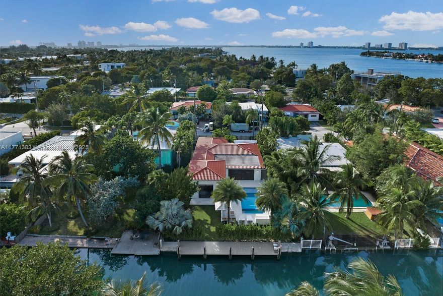 This exceptional turnkey home in the exclusive gated island of Biscayne Point was recently renovated and offers 60ft of frontage with no fixed bridges and direct bay access, plus a new seawall and expansive dock. The 4-bed, 4-bath home boasts nearly 2,500 sqft under A/C, porcelain tile floors, 11ft ceilings, impact glass, custom Italian doors & closets, an Italian kitchen with Viking appliances, 2 new A/C units, electric shades, a motorized gate, and a Sonos system. The primary suite features 12ft ceilings, a walk-in closet with a double-sided island, and a marble bath. The resort-like backyard has 10ft privacy hedges, a summer kitchen, and a new pool & spa.