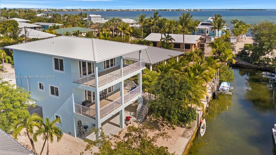 Welcome to your dream coastal retreat! This newer 4-bedroom, 3-bath luxury home offers the perfect blend of island elegance and modern comfort. Two spacious master suites provide privacy and flexibility, while the open-concept living space is framed by wide, breezy balconies, ideal for soaking in the sunrise or entertaining guests in true Keys style. Canal with direct access to the open ocean. No bridges, no hassle, just minutes to the Atlantic or Gulf. Inside, enjoy high-end finishes, plenty of natural light, and a layout designed for both relaxing and hosting. Whether you're seeking a full-time residence, vacation getaway, or income-producing investment, this waterfront gem checks every box. The boat lift permit application has been submitted and is anticipated to be approved by closing.