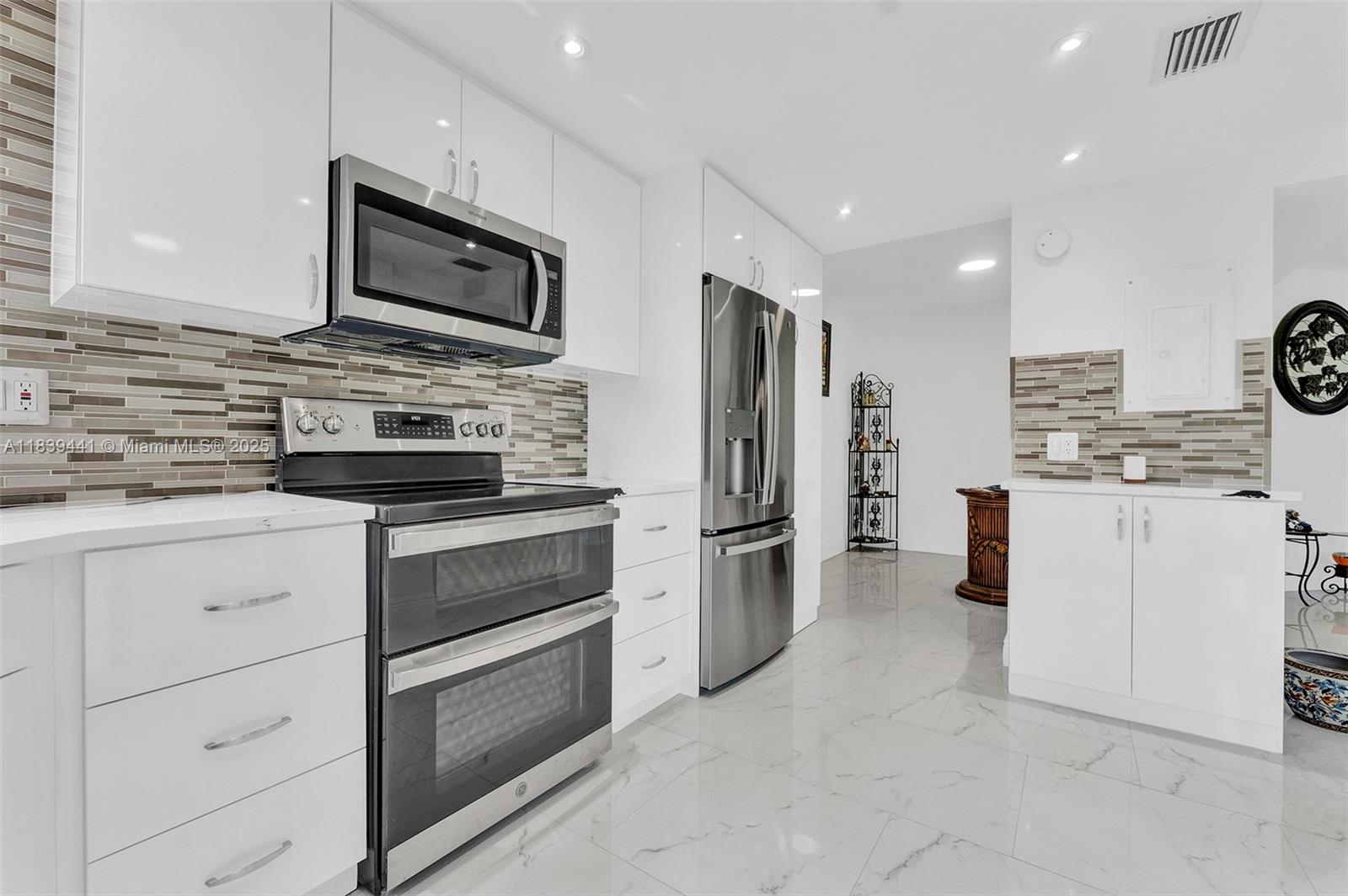 55+ Stunning 2 bed, 2 bath condo arguably the best unit for sale in the community! The owner invested over $100K in upgrades, including all impact glass windows and double impact glass protection on the patio. Inside, enjoy a beautifully renovated kitchen with stainless steel appliances, sleek custom cabinets, and a stylish backsplash. New porcelain tile floors and updated bathrooms add modern elegance throughout. The spacious layout includes a 25-foot balcony accessible from three rooms, bringing in tons of natural light. Located directly across from the clubhouse, pools, tennis, and pay-as-you-play golf. This vibrant adult community also features a café, fitness center, entertainment, classes, clubs, and more live the ultimate Florida lifestyle in a meticulously upgraded home!