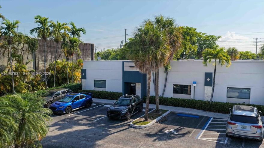 Exceptional end-cap unit featuring a welcoming reception area connected to conference room, 6 private offices, large open office floor plan, an employee lounge, supplies room, and warehouse area with 1 powered roll-up door. 2 restrooms, one of which includes a private shower, a practical amenity for active operational environments.

* Office/Warehouse Ratio ±68% / 32% 
* 7 assigned parking spaces plus an additional space available at the rear roll-up door. The unit also benefits from direct frontage onto the shared guest parking lot serving the center.
* Newly installed 240/120V, 200-Amp, 3-Phase electric service, providing robust capacity for a wide range of business operations.
* 2 independent A/C systems provide full coverage and built-in redundancy.
* Impact-rated windows and storefront entry door. 
* Insulated, hurricane-rated powered roll-up loading door for warehouse access.
* 10 year structural recertification completed in 2022.
BROCHURE AND FLOORPLAN ATTACHED