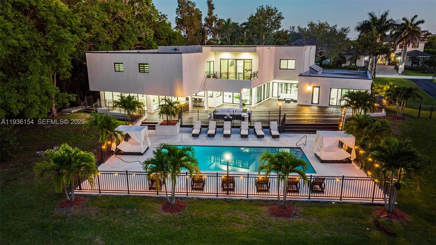 An exceptional opportunity to own a fully renovated 9-bedroom, 6-bath residence offering 8,582 sq ft and a total of 10,819 sq ft of adjusted living space. This home showcases a chef-inspired kitchen with high-end appliances, premium natural quartz countertops, a waterfall island, and custom cabinetry with pull-out drawers and generous pantry space. Rectified porcelain tile enhances the main living areas, while wood flooring adds warmth to all bedrooms. The second floor features an elegant luxury seating lounge, ideal for entertaining or unwinding. A first-floor bedroom enjoys backyard and pool views, and the primary suite upstairs impresses with tray ceilings, a freestanding soaking tub, and an expansive dual shower. A refined, move-in-ready luxury residence.