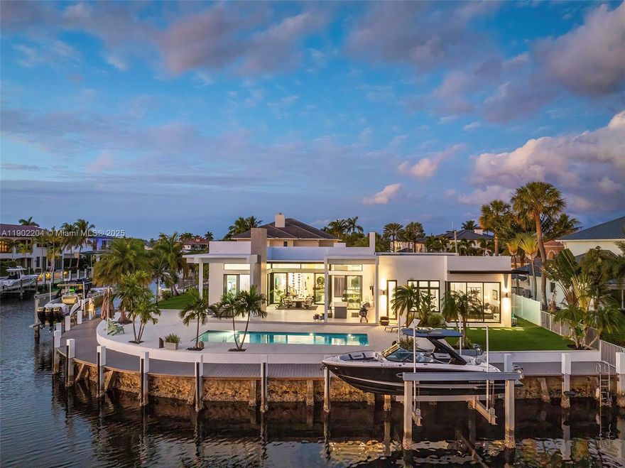 Experience the epitome of luxury in this brand-new modern ranch-style home built by renowned Zahn Builders, positioned perfectly on a coveted Southern point lot. Boasting over 200' of prime waterfrontage on the South Grand Canal, this gem is just minutes from the ocean. The home spans over 4,700 total square feet, including more than 3,000 square feet of outdoor space. Revel in the meticulous design with 3 primary-sized bedrooms, 4.5 lavish baths, a state-of-the-art gym, and an expansive 4-car garage. Outdoors, enjoy the convenience of two 25k LB lifts, perfect for your boating needs. The open-concept interior showcases no-expense-spared finishes, including mesmerizing backlit onyx countertops and select materials that exude opulence. A rare gem, this home defines sophisticated living.